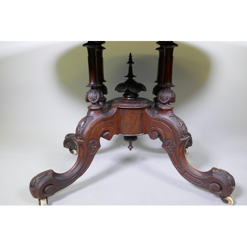 1002 - A good Victorian burr walnut loo/centre table with tilt top, raised on four carved columns on cabrio... 