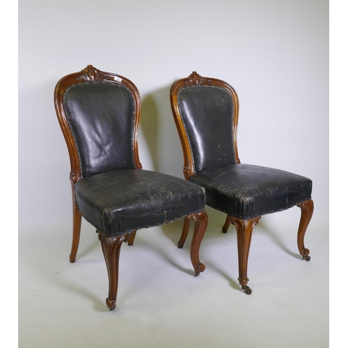 1004 - A pair of C19th Holland & Son walnut side/dining chairs with carved palmette decoration, studded... 