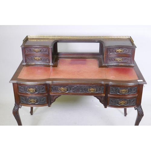 1010 - A Victorian Jas Shoolbred & Co mahogany kneehole desk, with pierced brass gallery over four draw... 