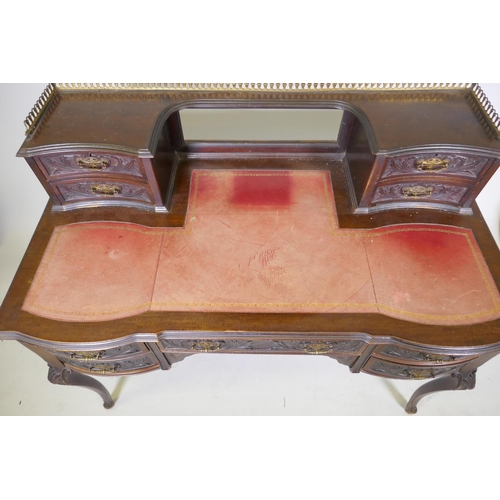 1010 - A Victorian Jas Shoolbred & Co mahogany kneehole desk, with pierced brass gallery over four draw... 