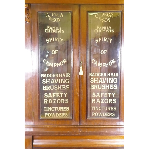 1011 - A Victorian mahogany bookcase, the glazed upper section with later decorative signwork over a base o... 