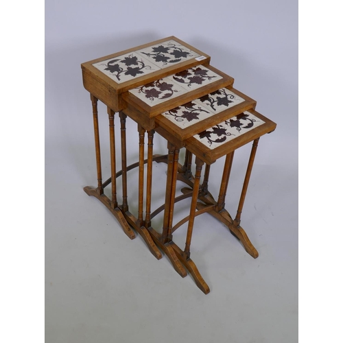 1020 - A quartetto 'nest' of four C19th faded rosewood tables, the tops inset with antique ceramic tiles de... 