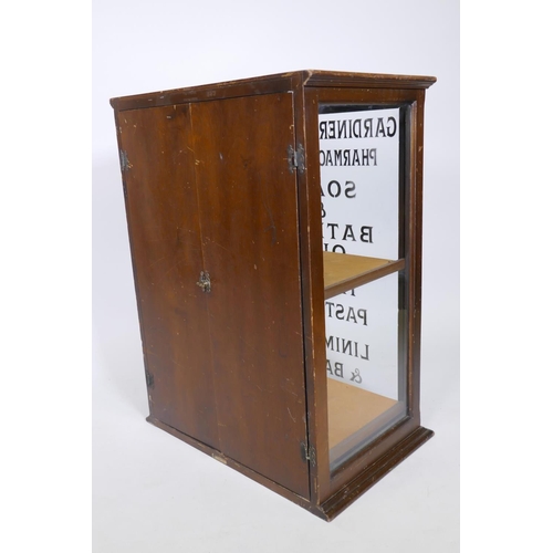 1021 - A mahogany shop display cabinet labelled T B Ford, Loudwater, Bucks, with sign written decoration, d... 