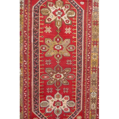 1022 - An antique Armenian red ground Karabagh rug, 135 x 270cm