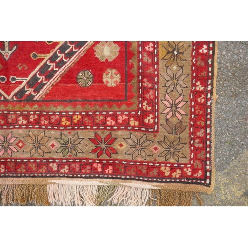 1022 - An antique Armenian red ground Karabagh rug, 135 x 270cm