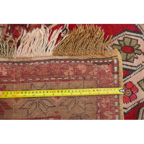 1022 - An antique Armenian red ground Karabagh rug, 135 x 270cm