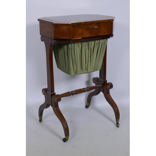 1025 - An early C19th figured mahogany work table, the top opening to reveal a lift out fitted tray over a ... 