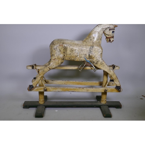 1028 - An antique painted pine rocking horse, on a trestle base, 112cm long, lacks tail