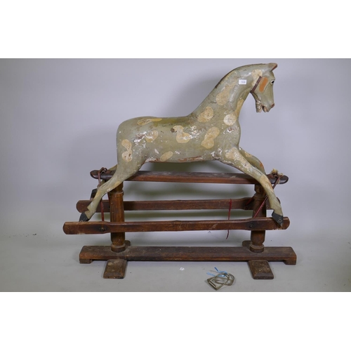 1029 - An antique painted pine dapple grey rocking horse on a trestle base, lacks mane, tail and bolts, 122... 