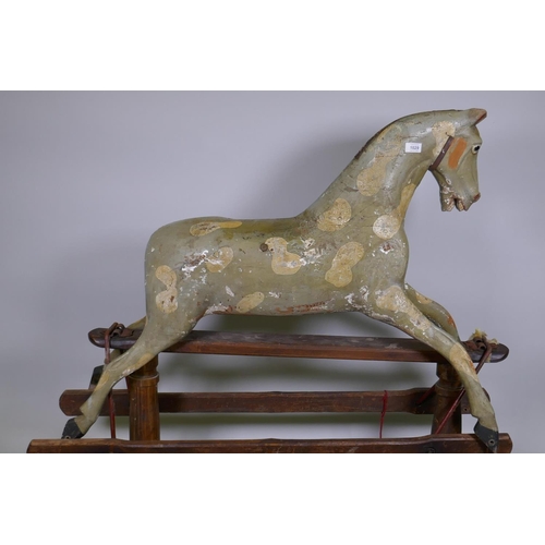 1029 - An antique painted pine dapple grey rocking horse on a trestle base, lacks mane, tail and bolts, 122... 