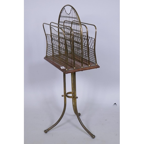 1040 - Antique brass and mahogany swivel action magazine/music rack, 90cm high