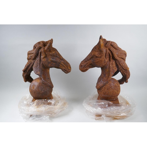 1046 - A pair of rusted cast iron horse heads, 45cm high