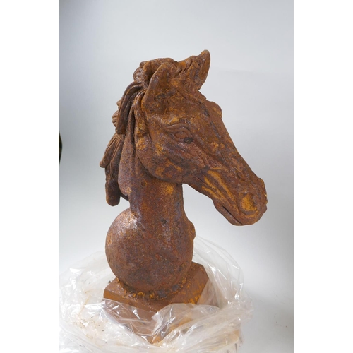 1046 - A pair of rusted cast iron horse heads, 45cm high