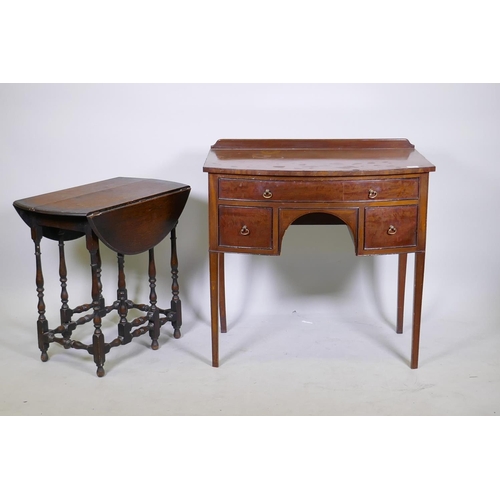 1054 - C19th mahogany bow front knee hole dressing/writing table with three drawers and brass handles, rais... 