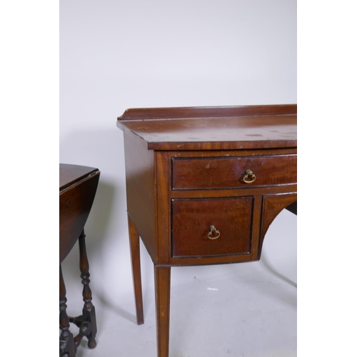 1054 - C19th mahogany bow front knee hole dressing/writing table with three drawers and brass handles, rais... 