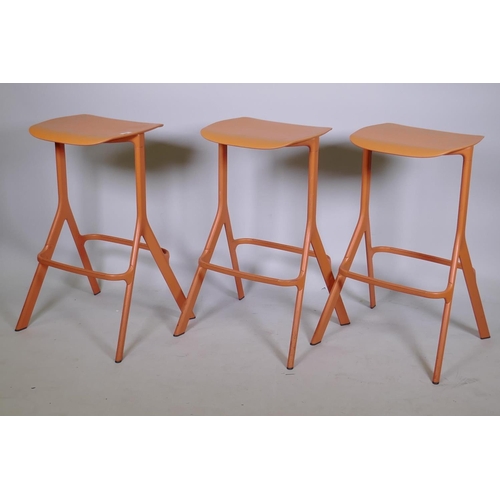 1057 - A set of three Allermuir coral colour kitchen/bar stools, 75cm high