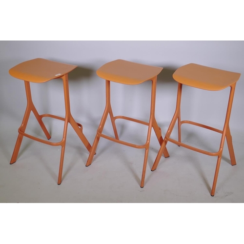 1057 - A set of three Allermuir coral colour kitchen/bar stools, 75cm high