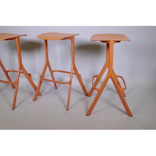 1057 - A set of three Allermuir coral colour kitchen/bar stools, 75cm high