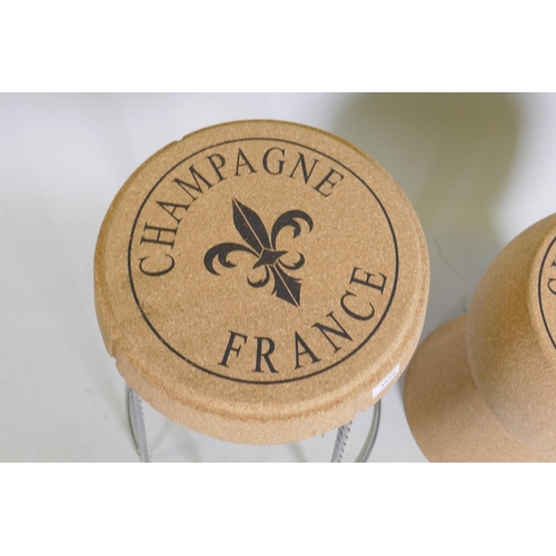 1059 - A pair of cork and metal stools in the form of champagne corks, 61cm high