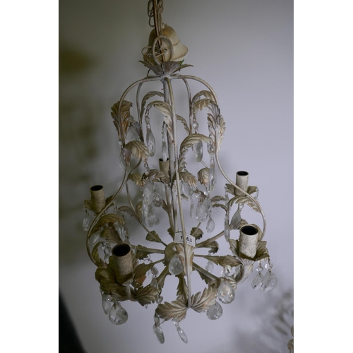 1063 - A pair of French style painted and parcel gilt metal five branch chandeliers with lustre drops, 54cm... 