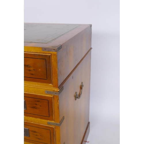 1066 - A yew wood veneered campaign style eleven drawer kneehole desk, with inset leather top and brass mou... 