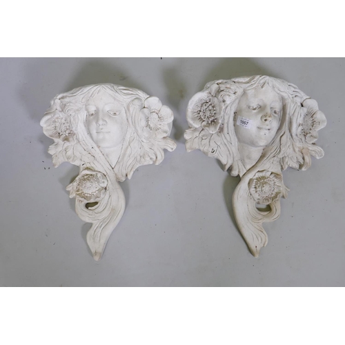 1067 - A pair of cast reconstituted stone wall pockets in the Art Nouveau style, 39cm long