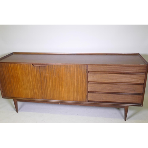 1068 - A mid century Richard Hornby for Heals afromosia side board with four drawers and two cupboards, rai... 