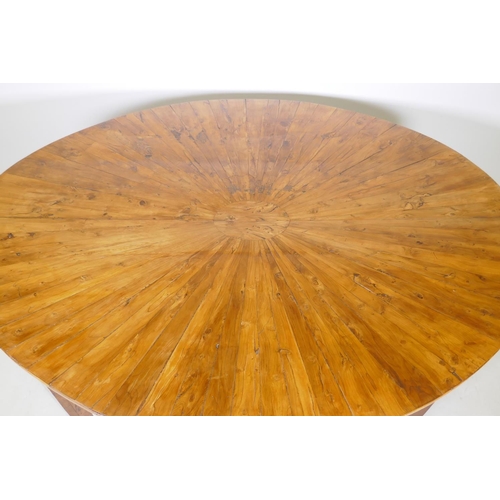 1069 - An antique yew wood oval centre table, with sunburst veneer top, the frieze with brass edge and rais... 