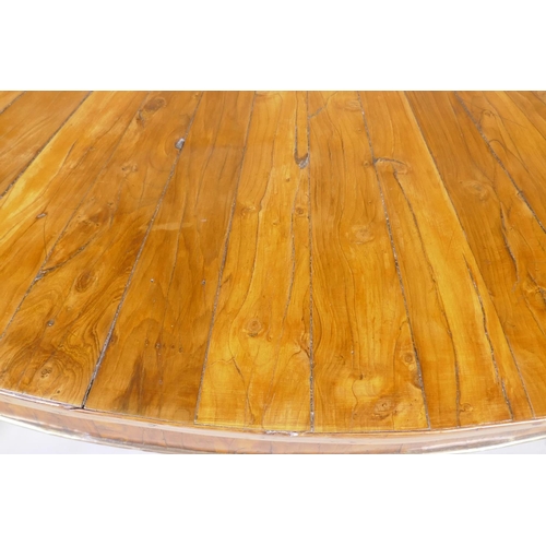 1069 - An antique yew wood oval centre table, with sunburst veneer top, the frieze with brass edge and rais... 