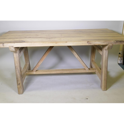 1077 - A bespoke hardwood tavern type dining table, with planked top and refectory style base united by a s... 