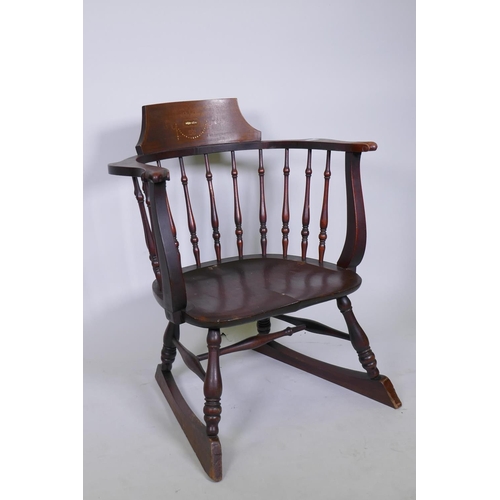 1079 - A Victorian stained and inlaid beechwood bow armchair with saddle seat, raised on turned supports wi... 