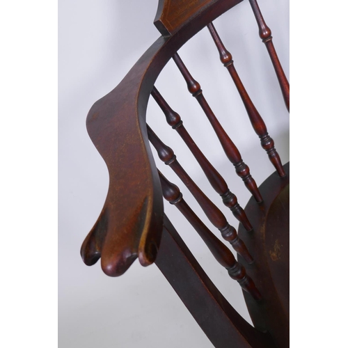 1079 - A Victorian stained and inlaid beechwood bow armchair with saddle seat, raised on turned supports wi... 