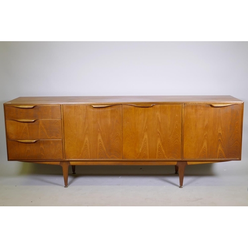 1098 - A mid century McIntosh & Co teak sideboard with three doors and a flight of three graduated draw... 