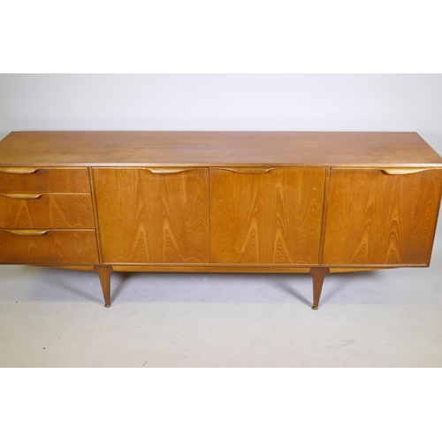 1098 - A mid century McIntosh & Co teak sideboard with three doors and a flight of three graduated draw... 