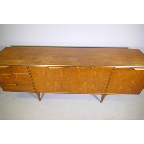 1098 - A mid century McIntosh & Co teak sideboard with three doors and a flight of three graduated draw... 