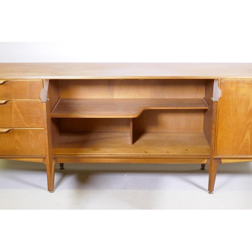 1098 - A mid century McIntosh & Co teak sideboard with three doors and a flight of three graduated draw... 