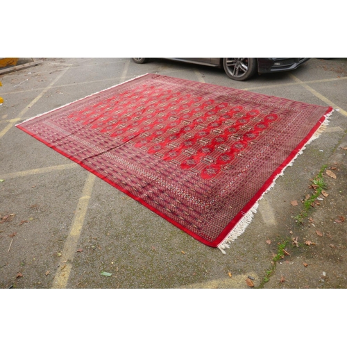 1101 - A Turkman fine red ground Bokhara rug, 290 x 360cm