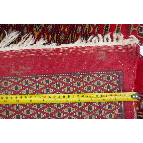 1101 - A Turkman fine red ground Bokhara rug, 290 x 360cm