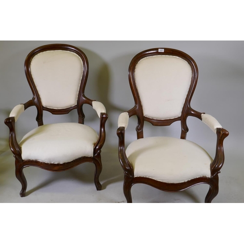 1121 - A pair of antique French Louis Philippe style show frame mahogany arm chairs, raised on cabriole sup... 