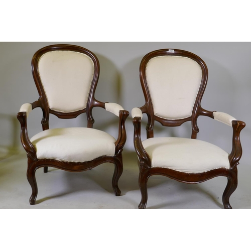 1121 - A pair of antique French Louis Philippe style show frame mahogany arm chairs, raised on cabriole sup... 