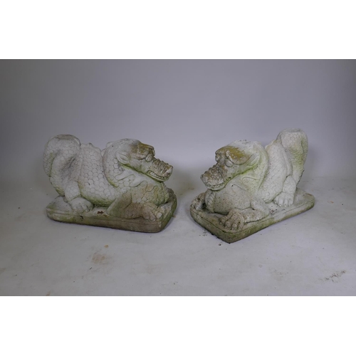 1151 - A pair of reconstituted stone dragons signed Helen Young, 54 x 34cm