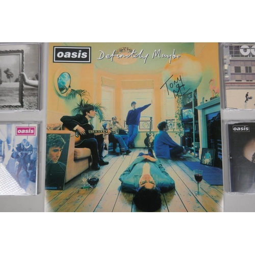 121 - A collection of Oasis related ephemera to include four original CD singles, Cigarettes and Alcohol, ... 