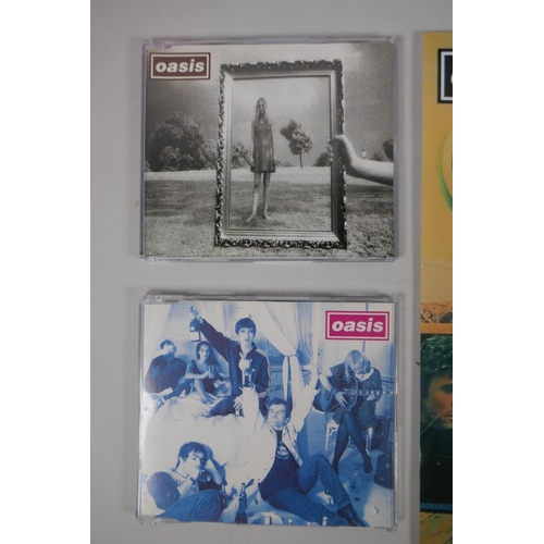 121 - A collection of Oasis related ephemera to include four original CD singles, Cigarettes and Alcohol, ... 