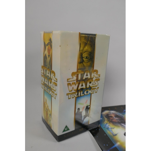 123 - A collection of Star Wars Collectables to include the Star Wars Trilogy digital remaster VHS box set... 