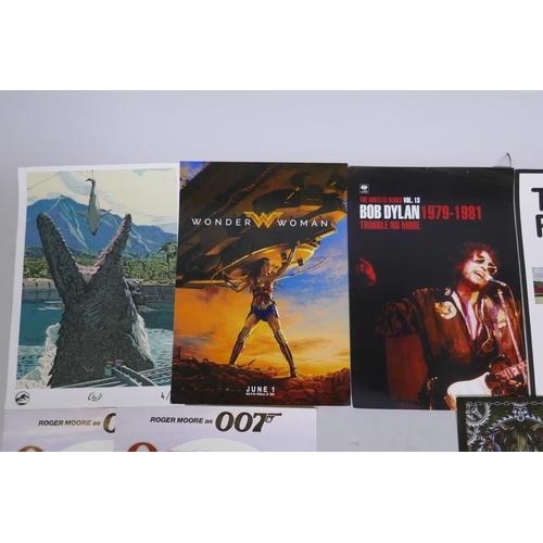 124 - A collection of movie theatre and music promotional posters including Pirates of the Caribbean Salaz... 