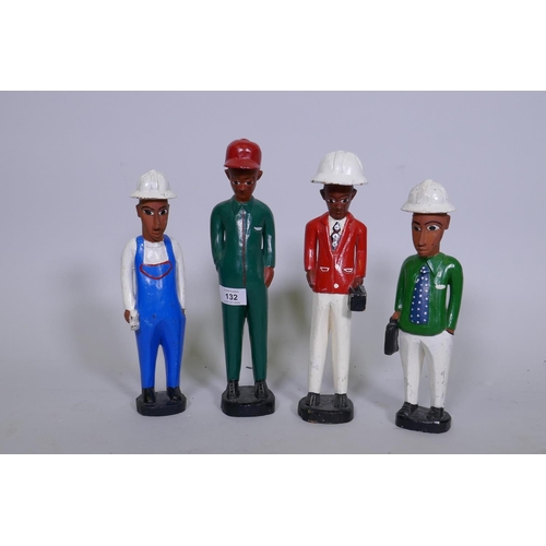 132 - A set of four African Colon carved and painted wood figures of construction workers, 29cm high