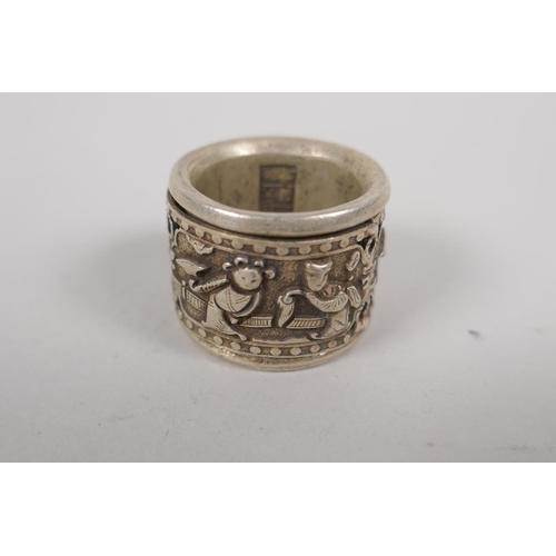 143 - A Chinese white metal archer's thumb ring with decorative figural rotating cuff, and two white metal... 