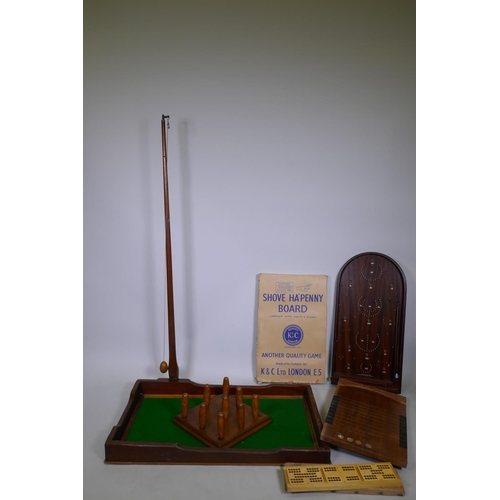 146 - An antique pub skittles game with mahogany tray and beechwood skittles, K&C Shove Ha'penny Board... 