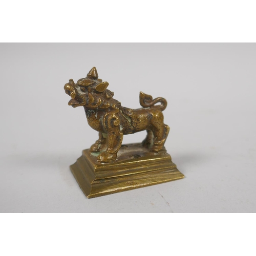 153 - A Chinese miniature bronze incense stick holder in the form of a kylin, and a miniature bronze Buddh... 