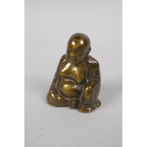 153 - A Chinese miniature bronze incense stick holder in the form of a kylin, and a miniature bronze Buddh... 